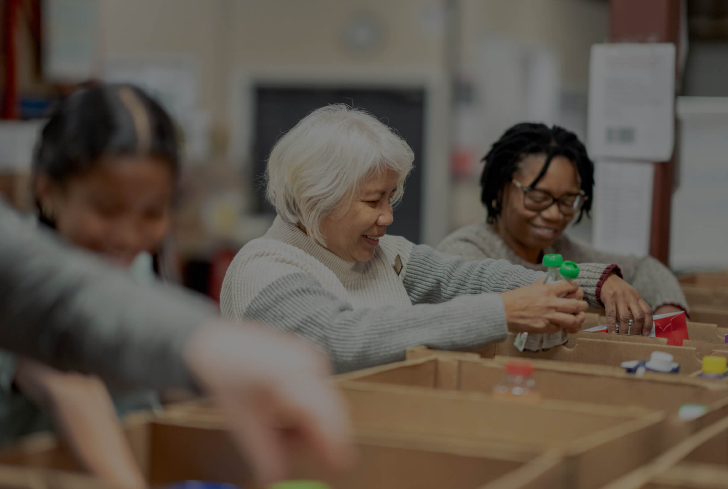 Volunteers packing at local food bank scaled