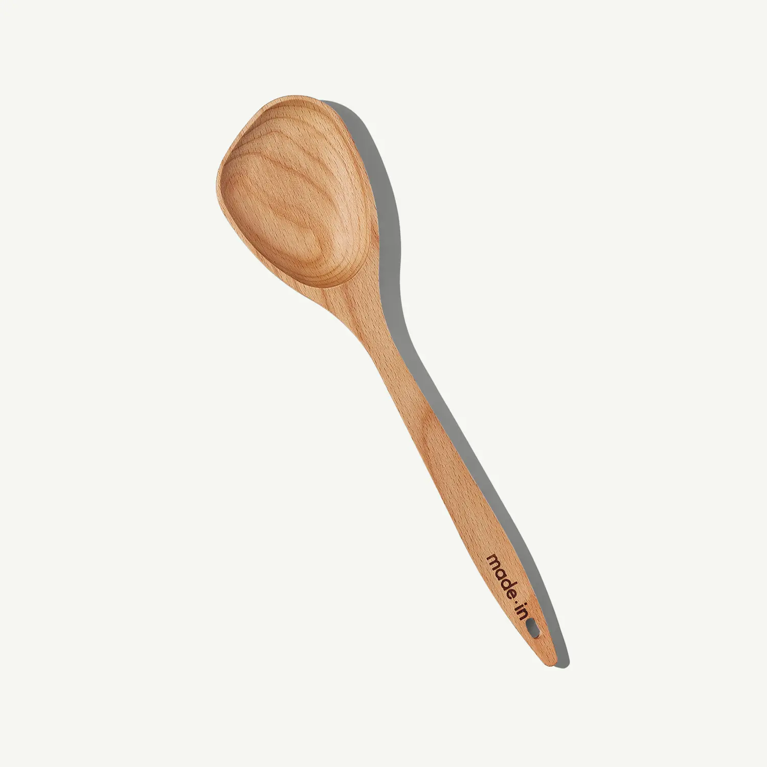 A wooden spoon is displayed on a plain background, showcasing its natural wood grain and a branded handle.