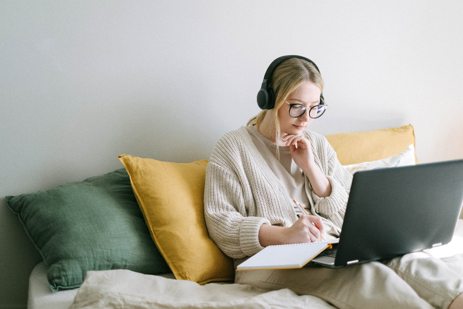 A person earns money online typing on a laptop in a home setting