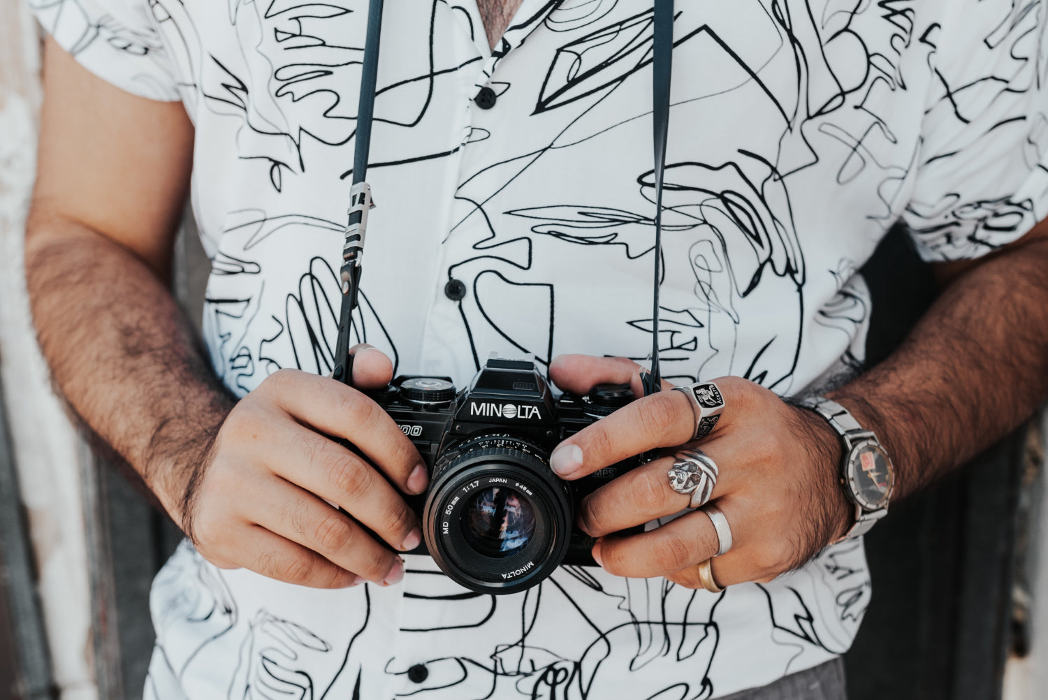 A person wears a digital camera around their neck