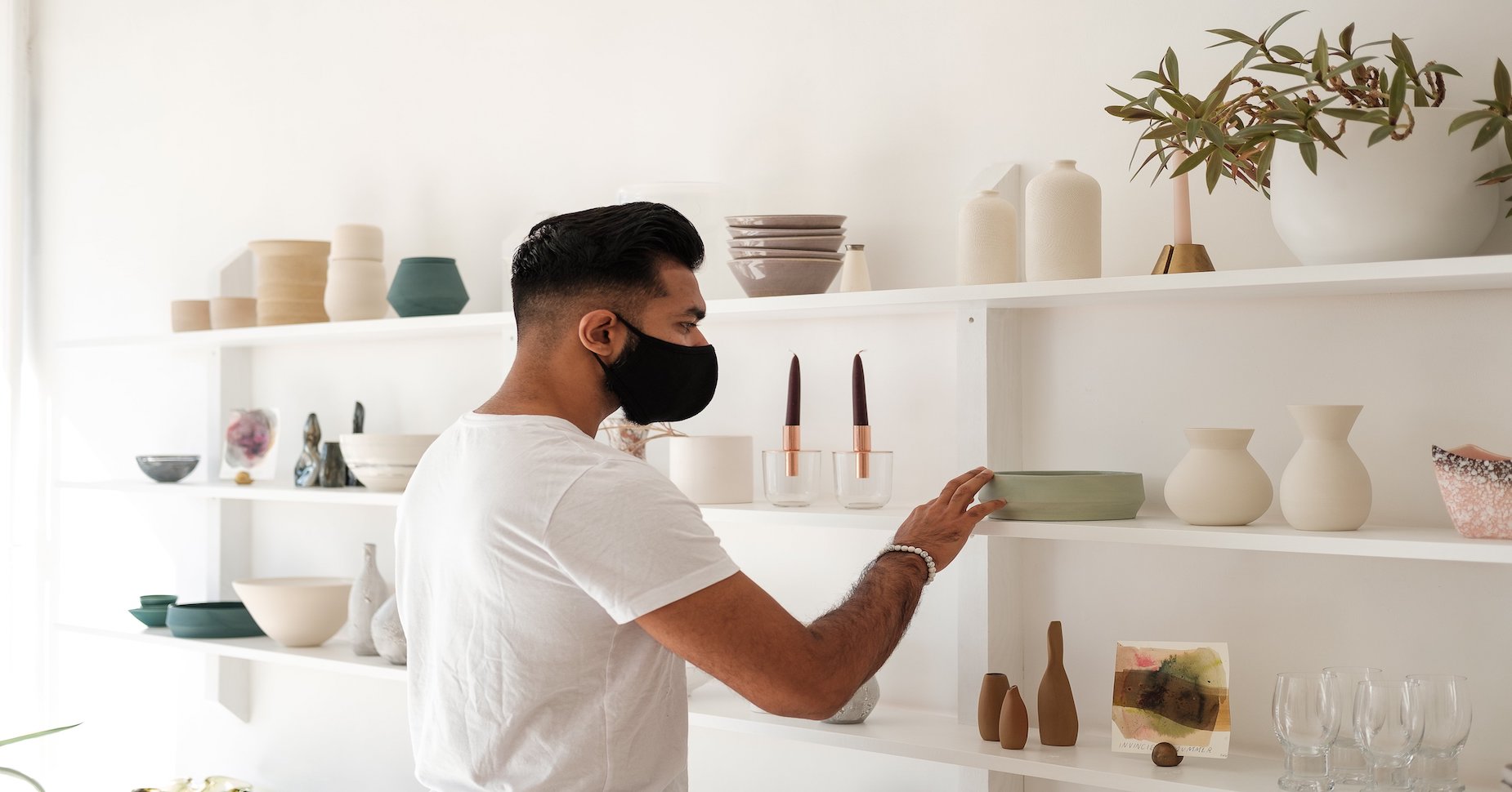 a guy fixing store shelves representing visual merchandising