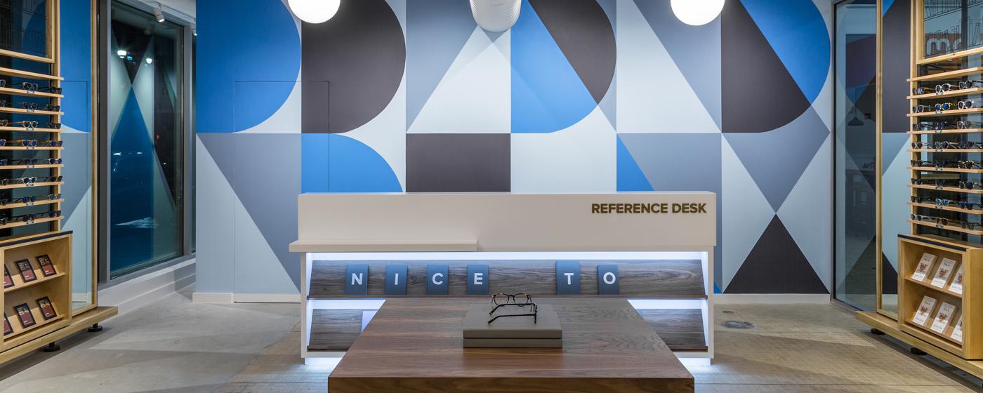 inside of a Warby Parker store looking at reference desk