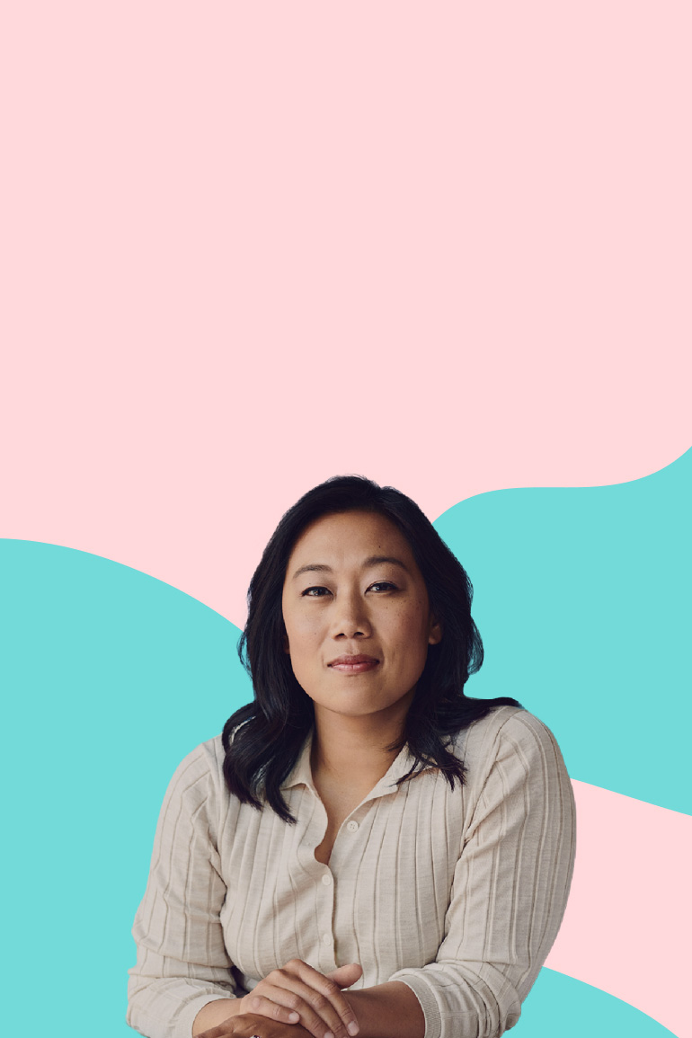 Priscilla Chan, Co-CEO of the Chan Zuckerberg Initiative, looking at the camera with her arms folded and in front of a pink and blue illustrated background.