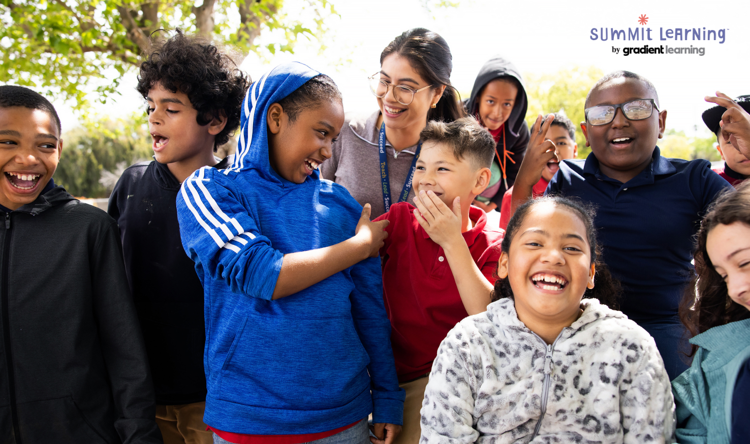 Multiple children outside smiling and laughing with Summit Learning logo.