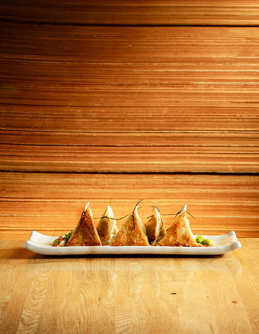 crab and black cod dumplings with chilli dressing, edamame and spring onions