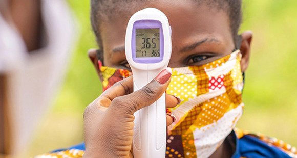 A child getting her temperature checked