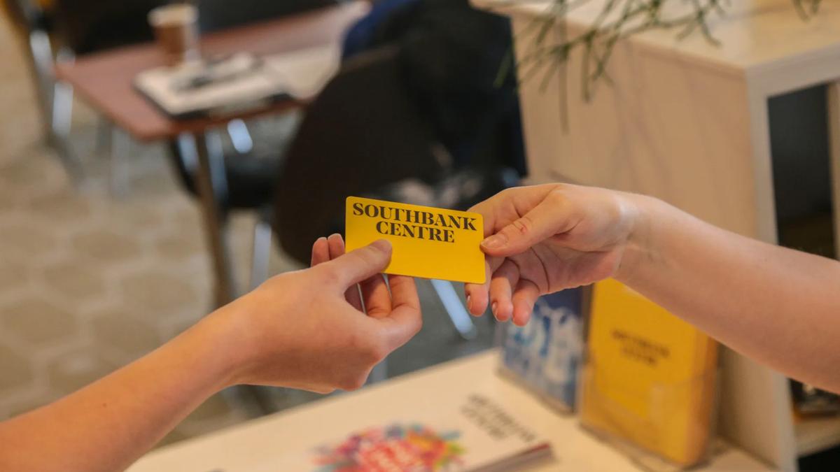 Two hands exchanging Southbank Centre membership card at the Southbank Centre Members Bar