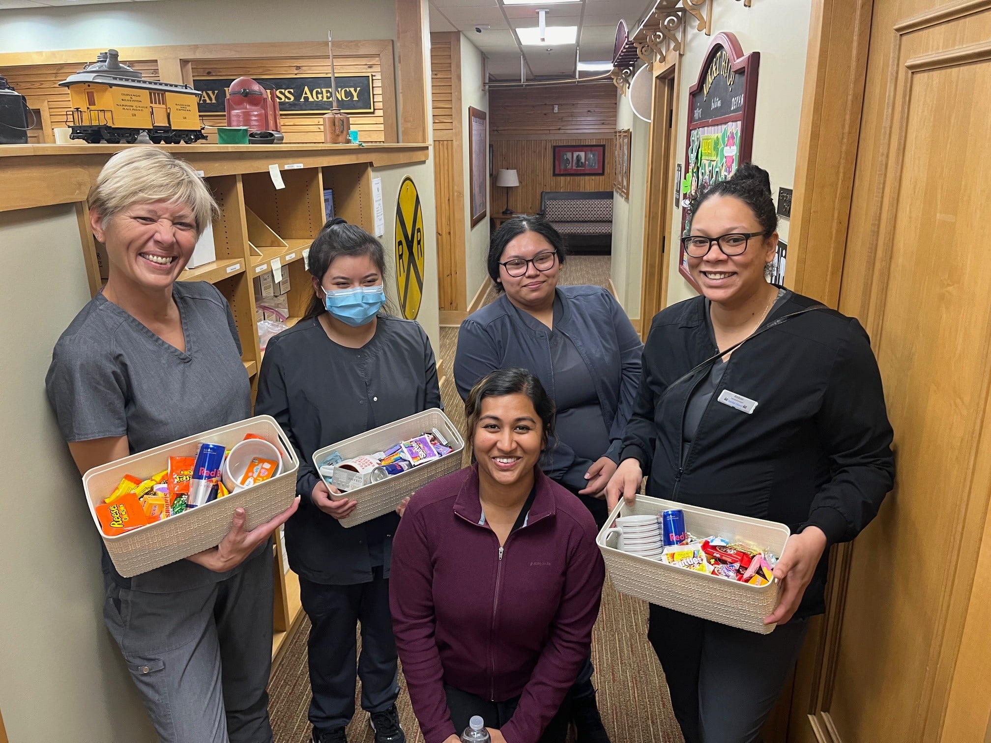 Dental Depot's Midwest City Dental Team holds boxes of candy for patients.