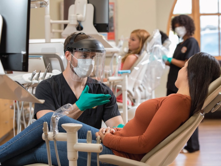 Female patient receiving emergency treatment from dental depot dentist