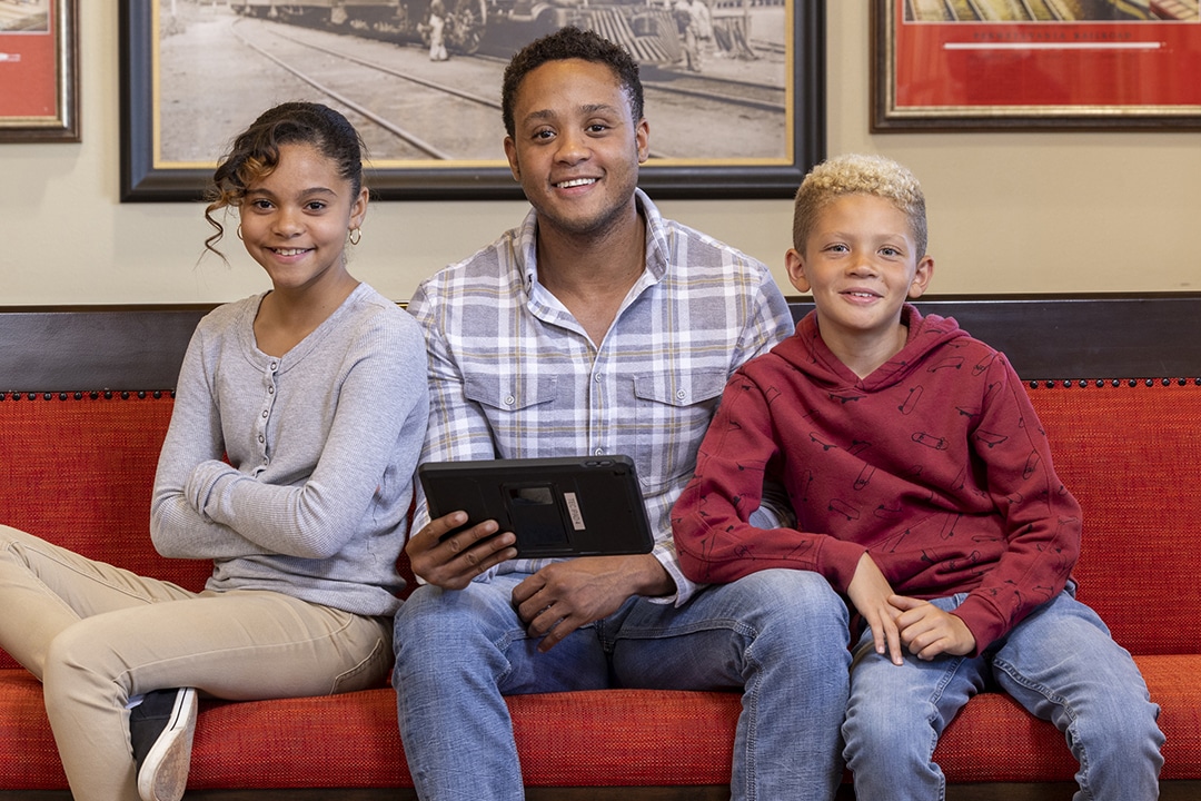 A family does online check in at dental depot