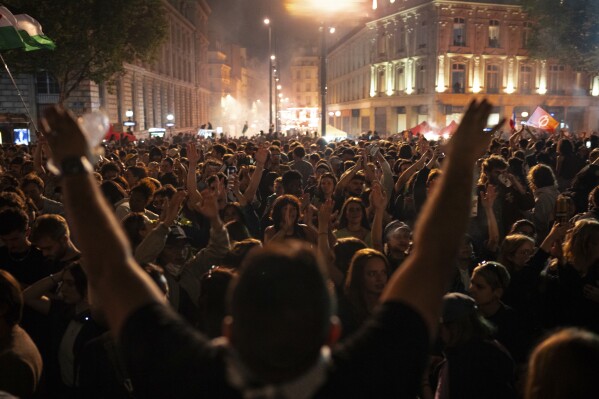 People gather at the Republique plaza after the second round of the legislative election, Sunday, July 7, 2024, in Paris. (AP Photo/Louise Delmotte)