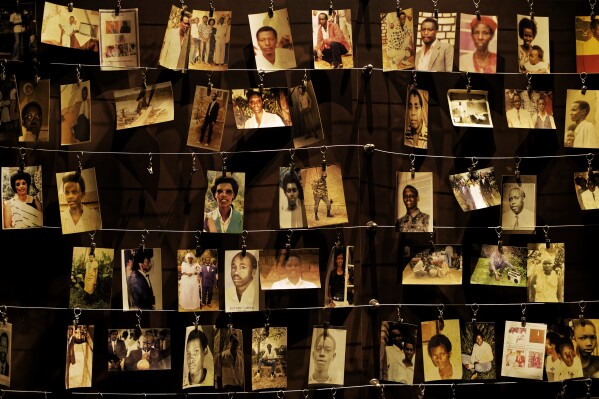 FILE - Family photographs of some of those who died hang on display in an exhibition at the Kigali Genocide Memorial centre in the capital Kigali, Rwanda Friday, April 5, 2019. (AP Photo/Ben Curtis, File)