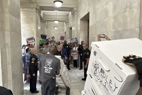 FILE - Boxes containing signatures supporting a proposed ballot measure to scale back Arkansas' abortion ban are delivered to a room in the state Capitol, Friday, July 5, 2024, in Little Rock, Ark. Supporters of a proposal to ask voters to scale back Arkansas’ abortion ban sued the state on Tuesday, July 16, for rejecting their petitions to get the measure on the November ballot. (AP Photo/Andrew DeMillo, File)