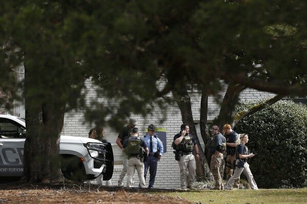 University of Georgia police along with Athens-Clarke County police, Georgia State Patrol and the Georgia Bureau of Investigation (GBI) search the Cielo Azulyk apartment complex after executing a search warrant Friday, Feb. 23. 2024 in Athens, Ga. Police arrested a suspect on Friday in the killing of a nursing student whose body was found on the University of Georgia campus in Athens, and said there's no further threat to the university community. (Joshua L. Jones/Athens Banner-Herald via AP)