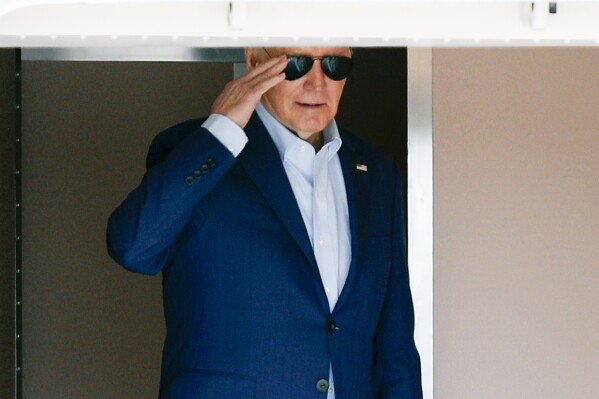 President Joe Biden returns a salute from Air Force One at Andrews Air Force Base, Md., Thursday, April 18, 2024. The President is traveling to Philadelphia. (AP Photo/Luis M. Alvarez)