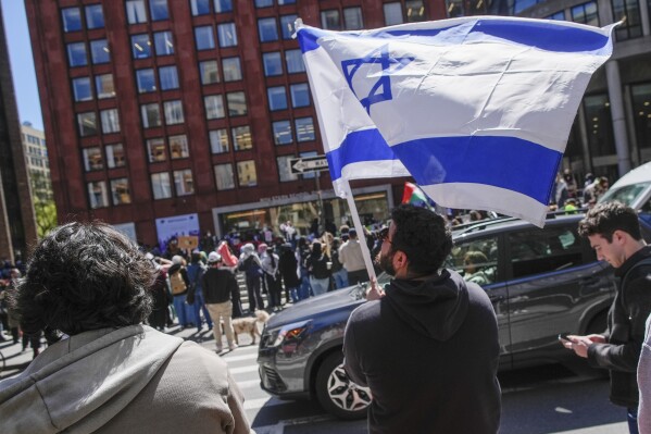 FILE - New York University students and pro-Israeli supporters rally across the street from where pro-Palestinian students and supporters rally outside the NYU Stern School of Business building, April 22, 2024, in New York. New York University has settled a lawsuit filed in November 2023 by three Jewish students who alleged that they had been subjected to “pervasive acts of hatred, discrimination, harassment, and intimidation” since the start of the Israel-Hamas war, NYU and the plaintiffs' attorneys announced Tuesday, July 9, 2024. (AP Photo/Mary Altaffer, File)