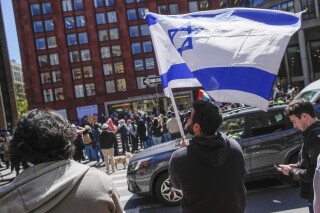 FILE - New York University students and pro-Israeli supporters rally across the street from where pro-Palestinian students and supporters rally outside the NYU Stern School of Business building, April 22, 2024, in New York. New York University has settled a lawsuit filed in November 2023 by three Jewish students who alleged that they had been subjected to “pervasive acts of hatred, discrimination, harassment, and intimidation” since the start of the Israel-Hamas war, NYU and the plaintiffs' attorneys announced Tuesday, July 9, 2024. (AP Photo/Mary Altaffer, File)