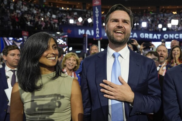 Republican vice presidential candidate Sen. JD Vance, R-Ohio, and his wife Usha Chilukuri Vance arrive on the floor during the first day of the 2024 Republican National Convention at the Fiserv Forum, Monday, July 15, 2024, in Milwaukee. (AP Photo/Carolyn Kaster)