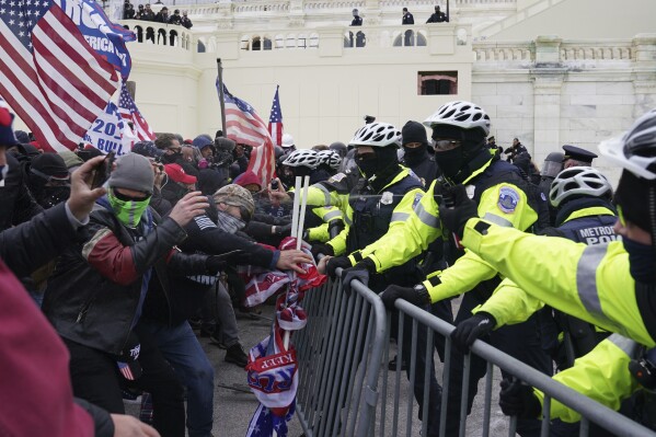 Rioters loyal to President Donald Trump clash with police at the U.S. Capitol on Jan. 6, 2021, in Washington. Liberal groups are trying to end Trump's attempt to return to the White House by arguing that he is no longer eligible to be president after trying to overturn the 2020 election results.(AP Photo/John Minchillo, File)