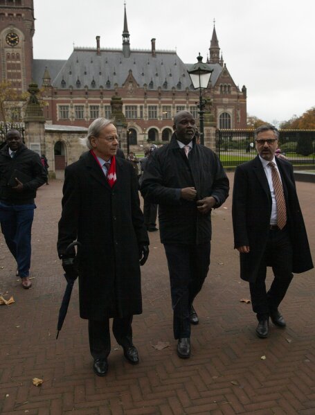 Gambia's delegation with Justice Minister Aboubacarr Tambadou, center, leave the Peace Palace which houses the International Court in The Hague, Netherlands, Monday, Nov. 11, 2019, after filing a case at the United Nations' highest court accusing Myanmar of genocide in its campaign against the Rohingya Muslim minority. A statement released Monday by lawyers for Gambia says the case also asks the court to order measures "to stop Myanmar's genocidal conduct immediately." (AP Photo/Peter Dejong)