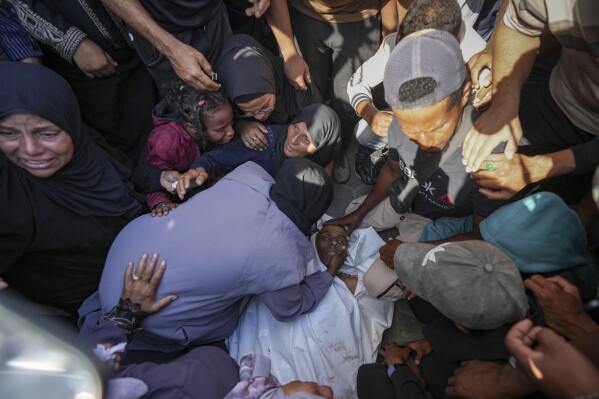 Palestinians mourn a man killed in the Israeli bombardment of the Gaza Strip at a hospital in Deir al Balah on Friday, June 7, 2024. (AP Photo/Abdel Kareem Hana)