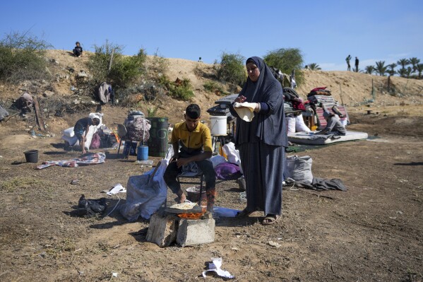 Displaced Palestinians arrive in central Gaza after fleeing from the southern Gaza city of Rafah in Deir al Balah, Gaza Strip, on Wednesday, May 7, 2024. The Israeli army has ordered tens of thousands of people to evacuate Rafah as it conducts a ground operation there. (AP Photo/Abdel Kareem Hana)