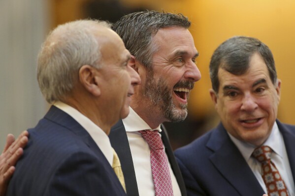 FILE - Michael Rulli, center, Ohio Senate Republican from the 33rd District, speaks with colleagues at the Ohio State House Senate Chambers in Columbus, Ohio, Wednesday, Feb. 28, 2024. (AP Photo/Joe Maiorana, File)