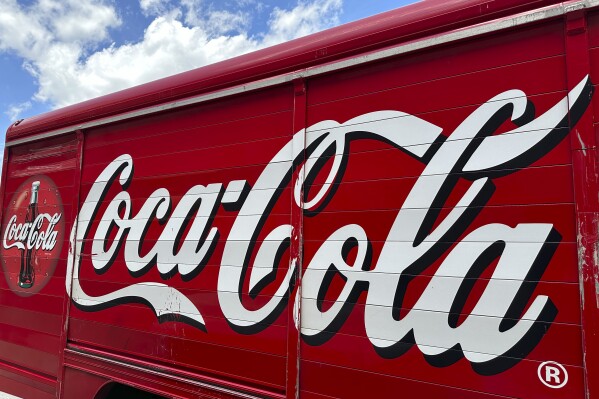 FILE - The Coca-Cola logo adorns the side of a delivery truck May 15, 2024, in southeast Denver. Coca-Cola reports earnings on Tuesday, July 23, 2024. (AP Photo/David Zalubowski, File)