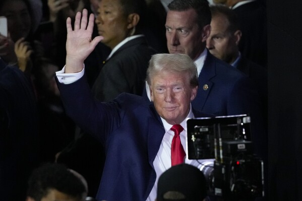 Republican presidential candidate former President Donald Trump waves to supporters as he arrives to the first day of the Republican National Convention Monday, July 15, 2024, in Milwaukee. (AP Photo/J. Scott Applewhite)