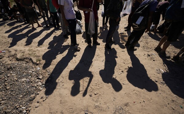 Migrants wait to be processed by the U.S. Customs and Border Patrol after they crossed the Rio Grande and entered the U.S. from Mexico, Oct. 19, 2023, in Eagle Pass, Texas. (AP Photo/Eric Gay, File)