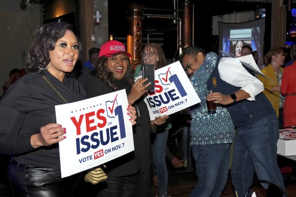 Hamilton County Commissioner Alicia Reece, second from left, joins voters in reacting to the passage of Ohio Issue 1, a ballot measure to amend the state constitution and establish a right to abortion, at an election night party hosted by the Hamilton County Democratic Party, Tuesday, Nov. 7, 2023, at Knox Joseph Distillery in the Over-the-Rhine neighborhood of Cincinnati. (Kareem Elgazzar/The Cincinnati Enquirer via AP)
