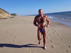 Hairy, bearded, bulging Boatinrob running slow motion on the beach 0126 gif