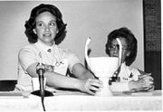 Jacqueline Lichtenberg holding the Kraith just presented by a fan. In the background is Debbie Goldstein, who with Carol Lynn edited all the volumes of Kraith Collected