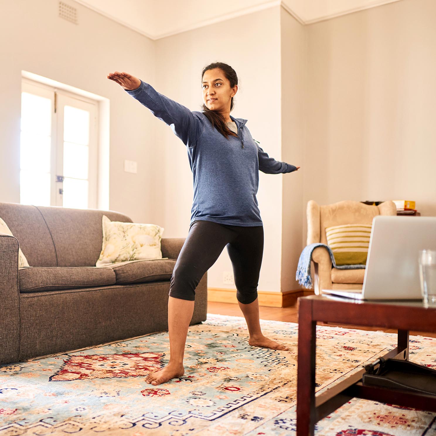 Image of a woman doing yoga at home