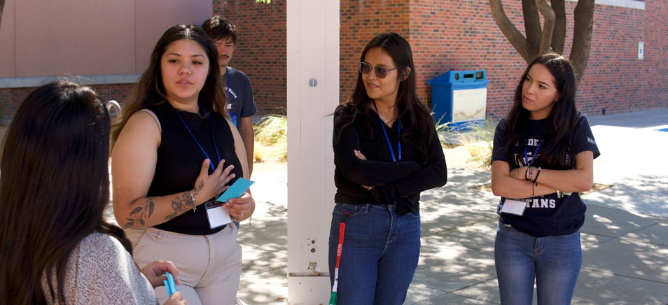 students standing outside talking.