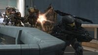 Six leading a trio of army troopers inside SWORD Base.