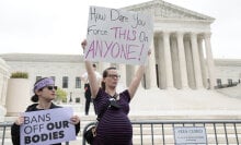 A pregnant pro-choice protestor stands in front of the Supreme Court after Roe v Wade leak