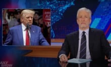 A man sits behind a talk show desk looking disappointed. In the top left is an image of another man standing at a podium, surrounded by a crowd.