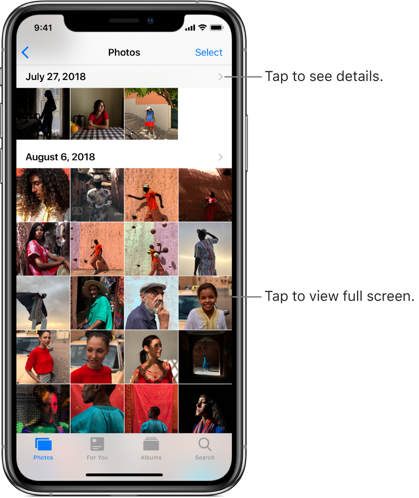 The Photos app, at the bottom of the screen from left to right are the Photos, For You, Albums, and Search tabs. The Photos tab is selected and the screen above shows a grid of photo thumbnails organized in groups by moment. Above each moment is the date the photos were taken. Tap the date to display details about the moment. Tap a photo thumbnail to display the photo in full screen.