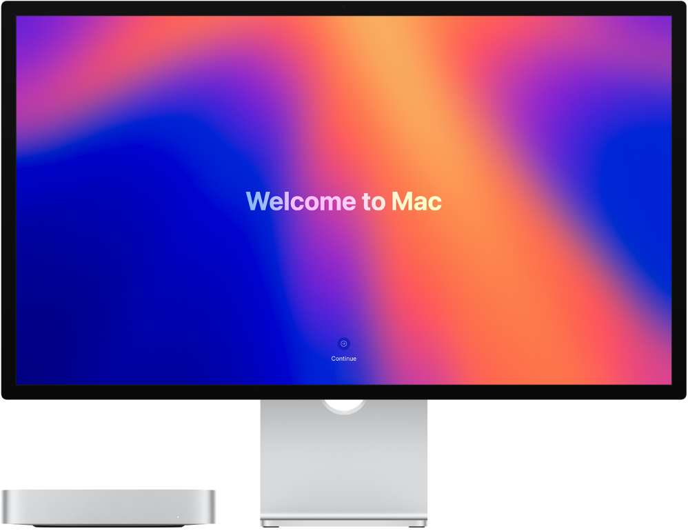 Mac mini ja Studio Display ovat vierekkäin, näytöllä on teksti ”Tervetuloa Maciin”.