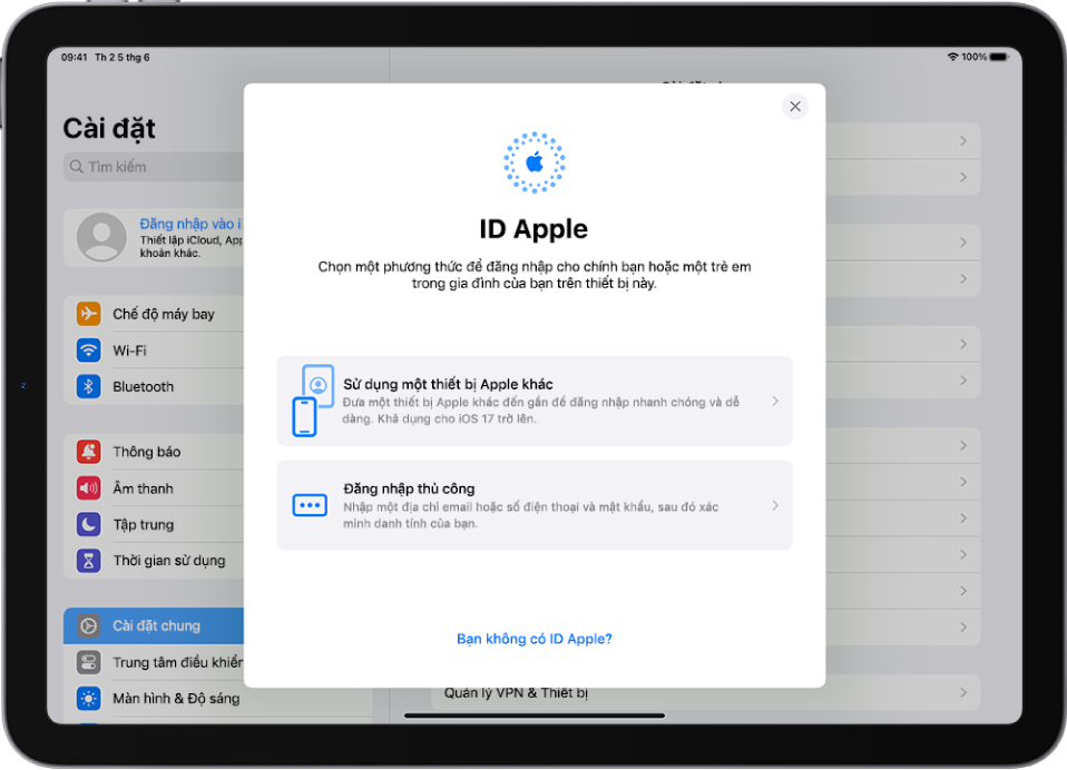 Màn hình Cài đặt, với hộp thoại đăng nhập ID Apple ở giữa màn hình.