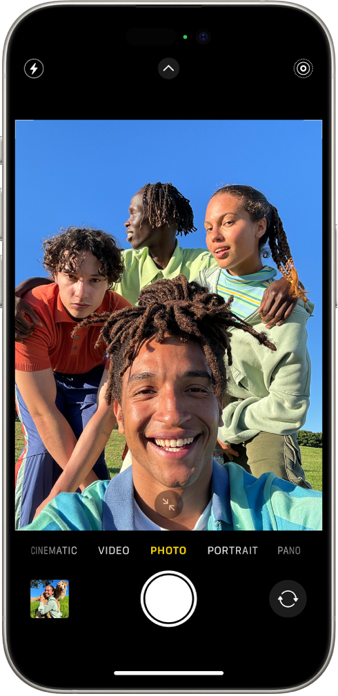 The Camera screen in Photo mode, showing four people in the Camera frame.