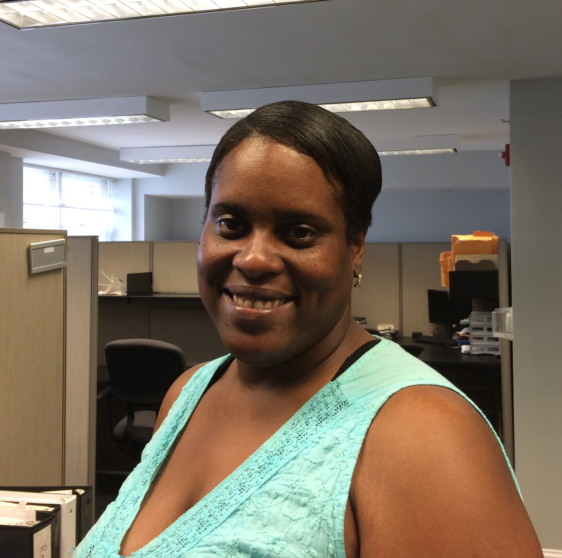 Patrice Wright smiling near her desk