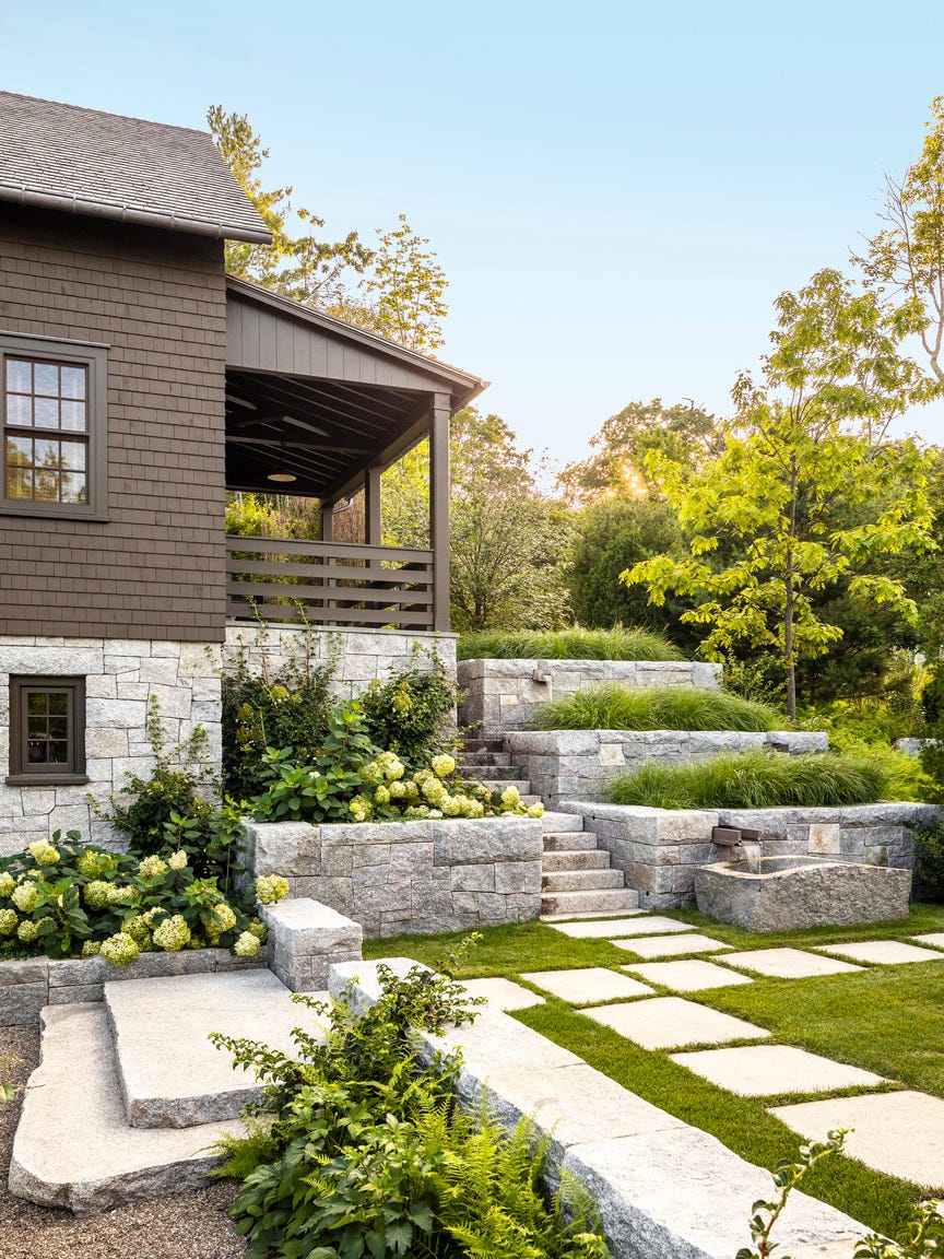 a house with retaining walls and hydrangeas