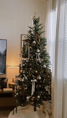 This may contain: a decorated christmas tree in a living room