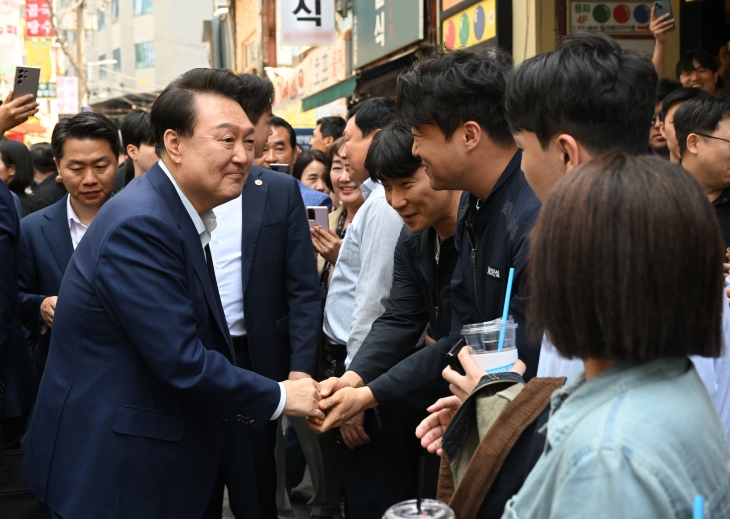 윤석열 대통령이 10일 서울 중구 다동 무교동 음식문화의 거리 일대에서 청계천으로 이동 중 직장인, 시민들을 만나 인사하고 있다. 대통령실 제공