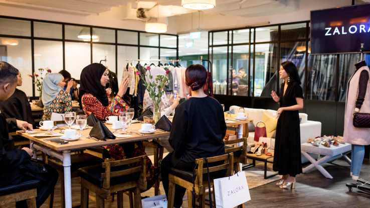 People at an office event at Zalora. 