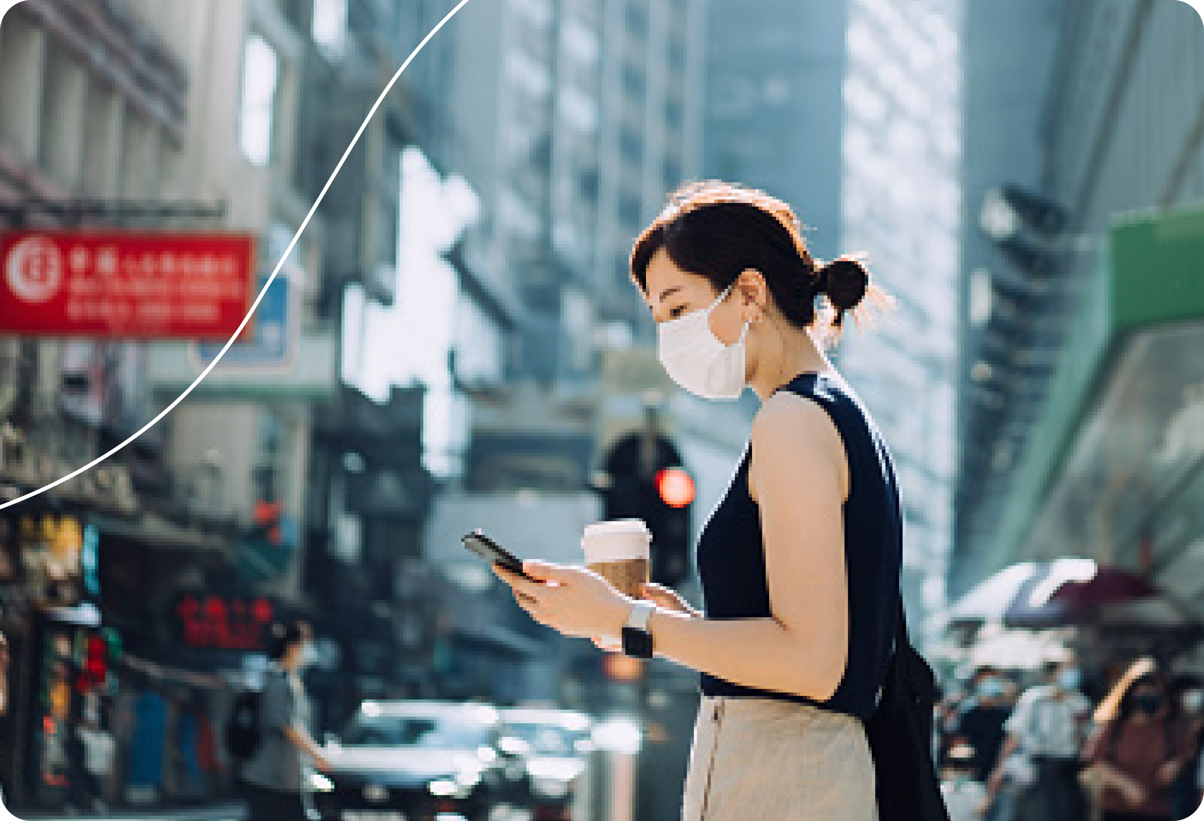 Woman wearing mask, looking at phone