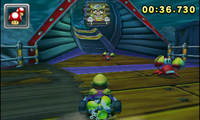 Wario in Wario Shipyard, driving to a sign displaying Bull Wario in Mario Kart 7