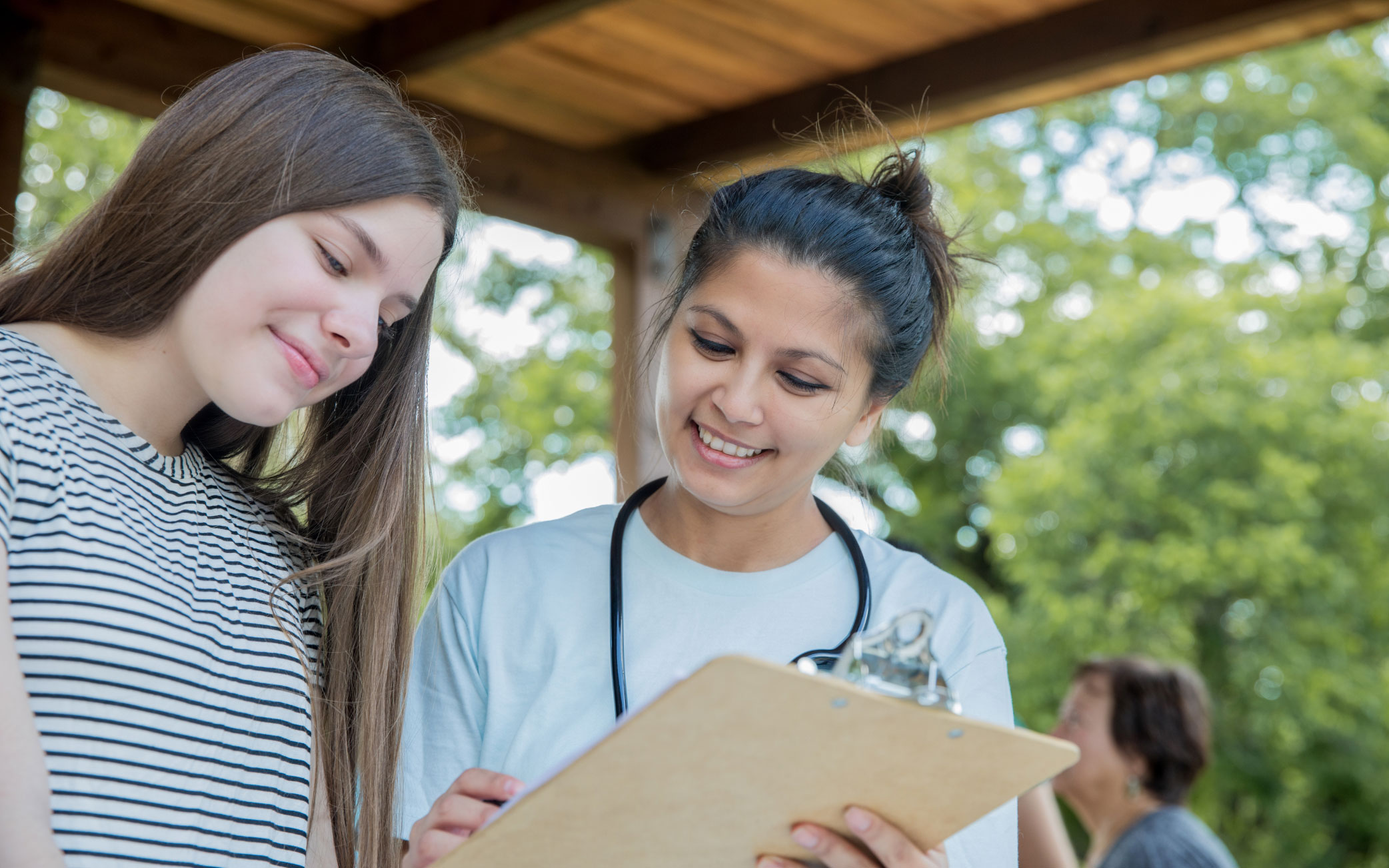 one person shows clipboard to another person